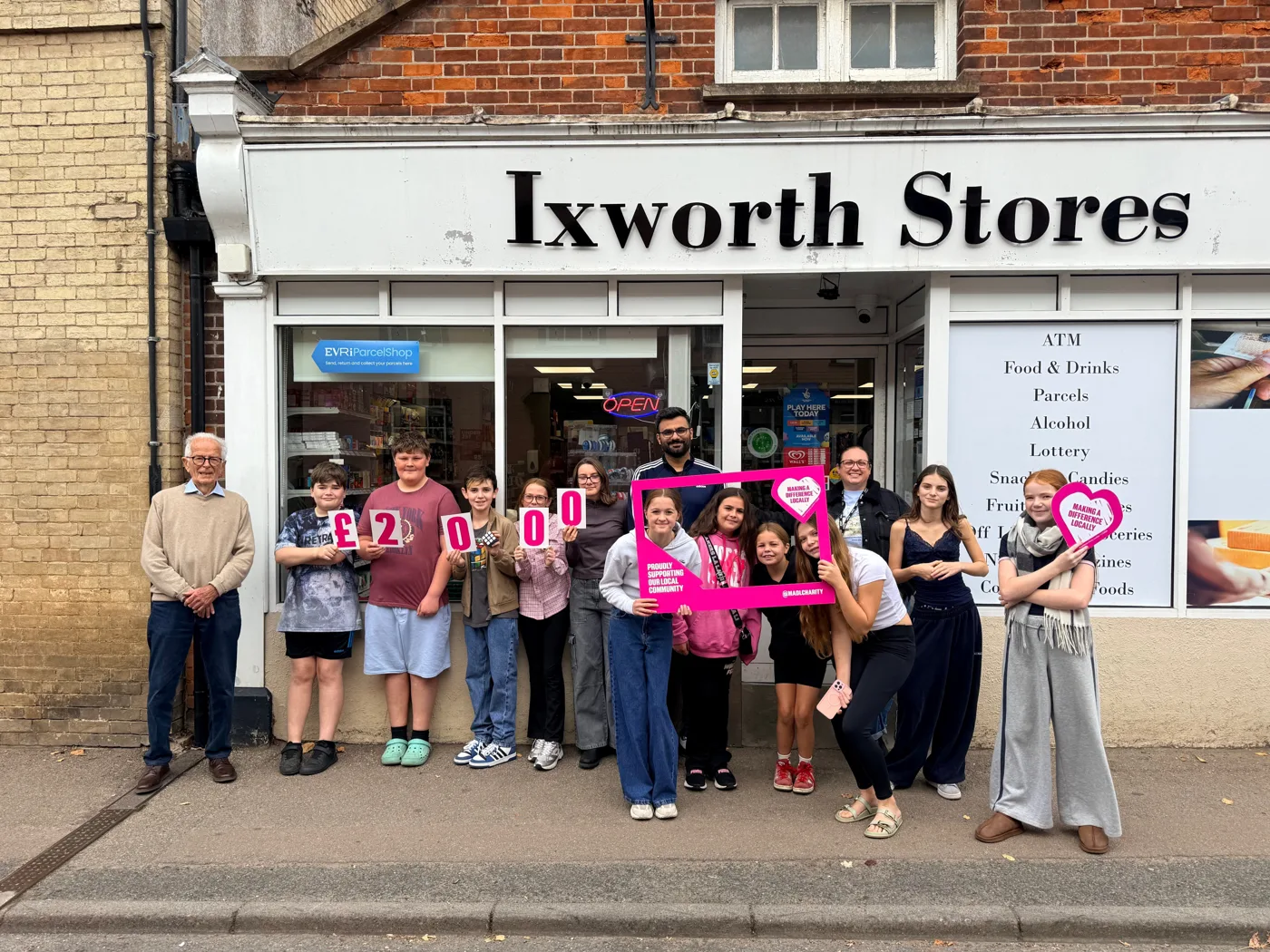 Members of Ixworth Youth Junction outside Ixworth Stores on High Street with owner Falgun Odedara, volunteer Nick Laughton and lead youth worker Honor Warner